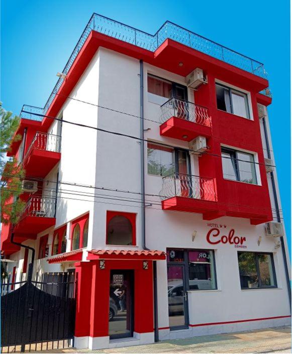 a red and white building with a colgate at Hotel Color in Asenovgrad