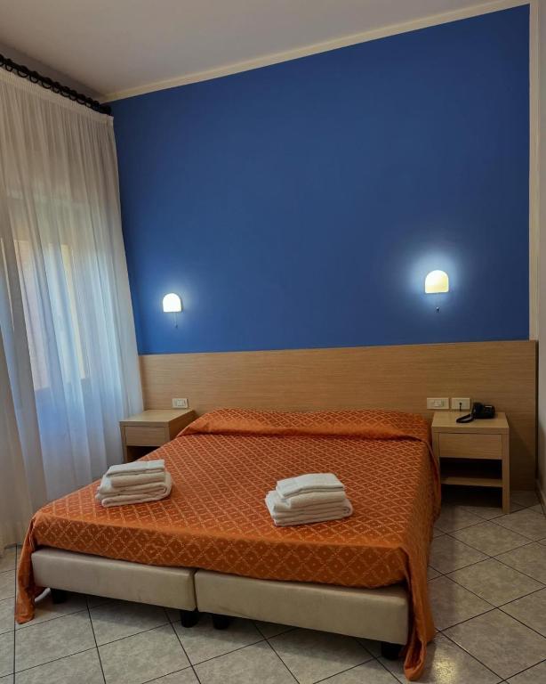 Postel nebo postele na pokoji v ubytování Albergo La Posta Arezzo