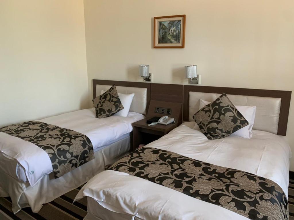 Postel nebo postele na pokoji v ubytování Hotel River Kinmen
