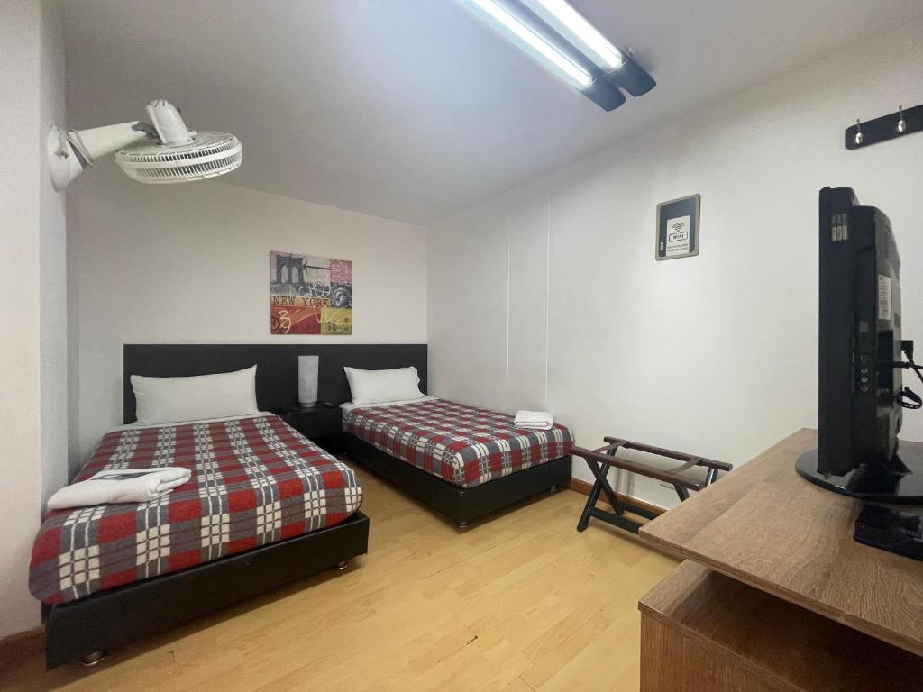 Postel nebo postele na pokoji v ubytování Hostal Lleras Calle 8