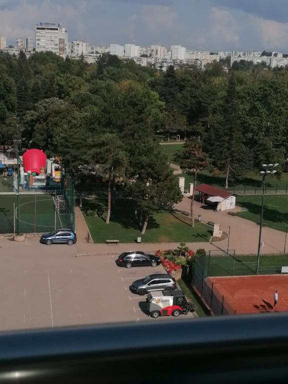 a group of cars parked in a parking lot at Апартамент Градски Парк in Dobrich