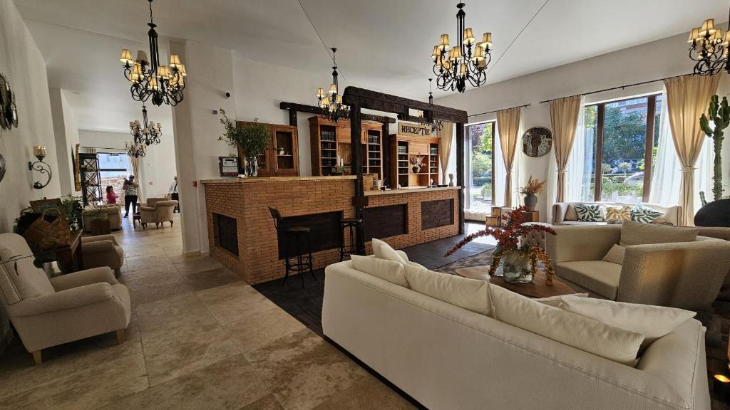 a living room with couches and a fireplace at Aria Suites in Târgovişte