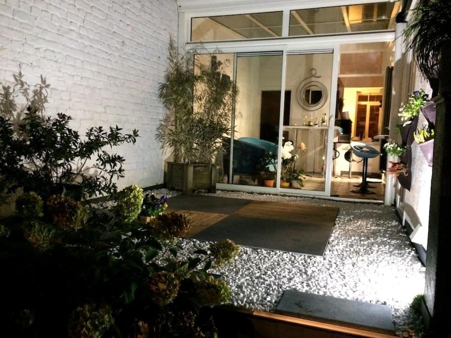 una porta aperta per una casa con piante in vaso di Maison ZEN de ville à 2 pas de la PLAGE a Dunkerque