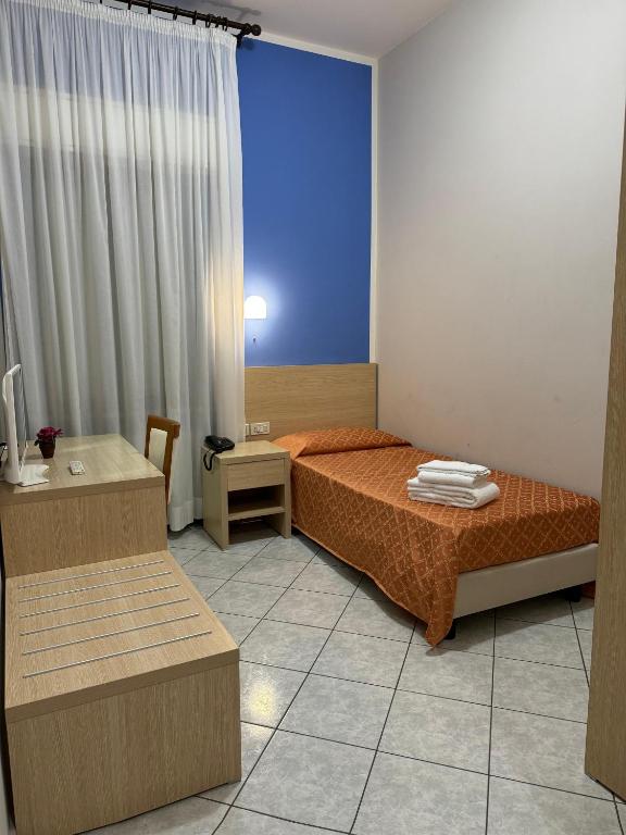 Postel nebo postele na pokoji v ubytování Albergo La Posta Arezzo