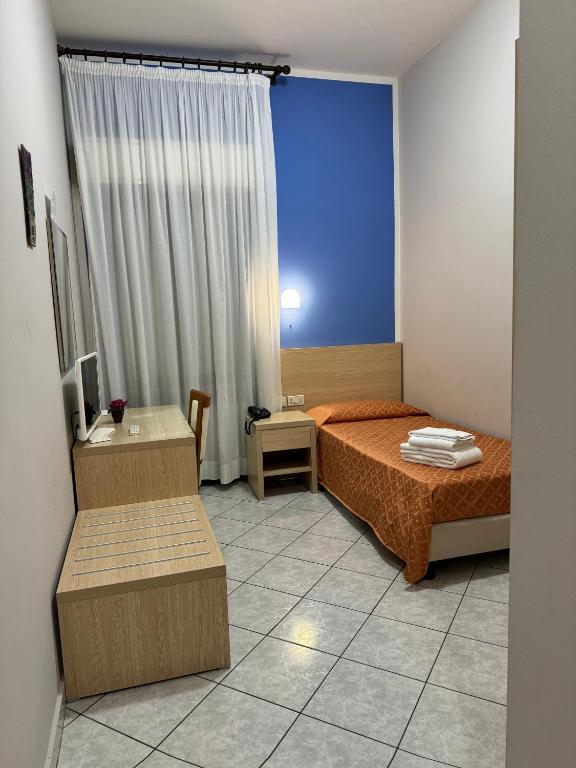 Postel nebo postele na pokoji v ubytování Albergo La Posta Arezzo