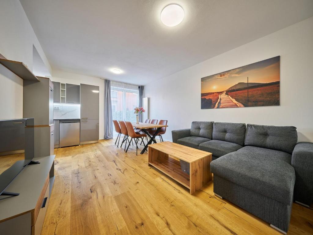 a living room with a couch and a table at Apartment Trendy Mountain Terrace Retreat by Interhome in Svoboda nad Úpou