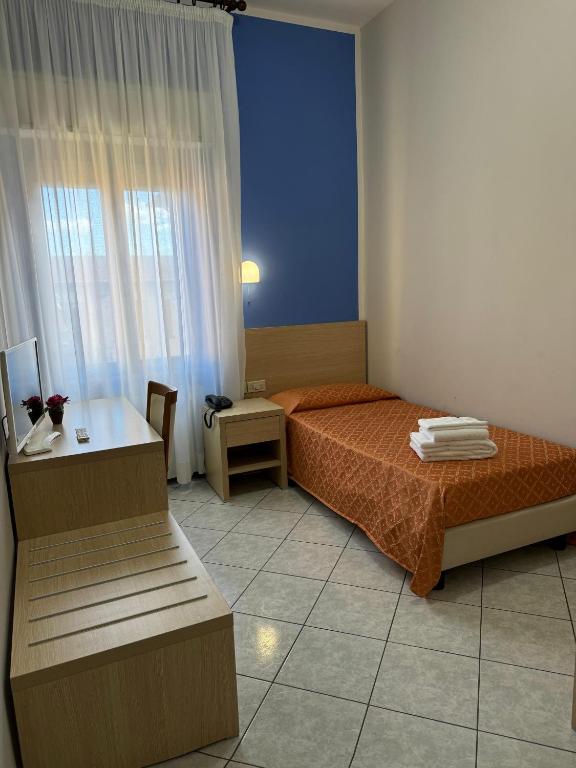 Postel nebo postele na pokoji v ubytování Albergo La Posta Arezzo