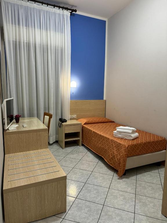 Postel nebo postele na pokoji v ubytování Albergo La Posta Arezzo