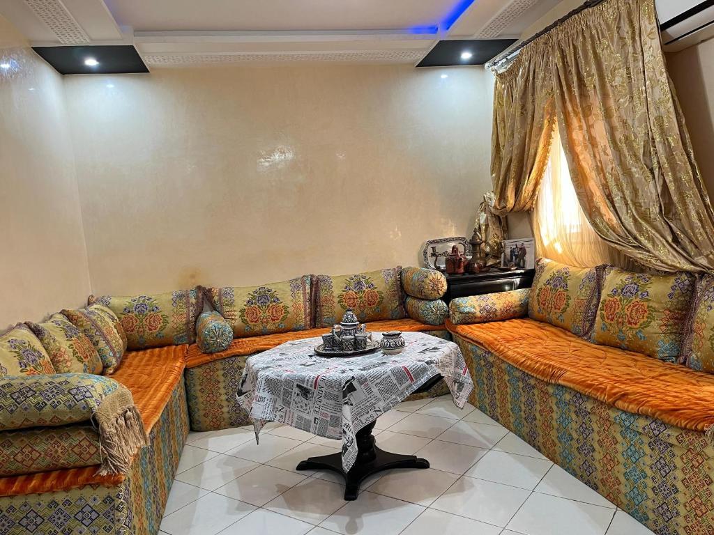 a living room with a couch and a table at Modern Moroccan apartment near the beach in Safi in Safi