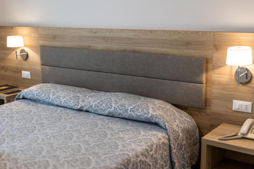Postel nebo postele na pokoji v ubytování Hotel Smeraldo