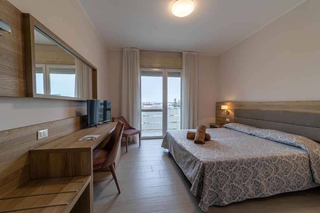 Postel nebo postele na pokoji v ubytování Hotel Smeraldo