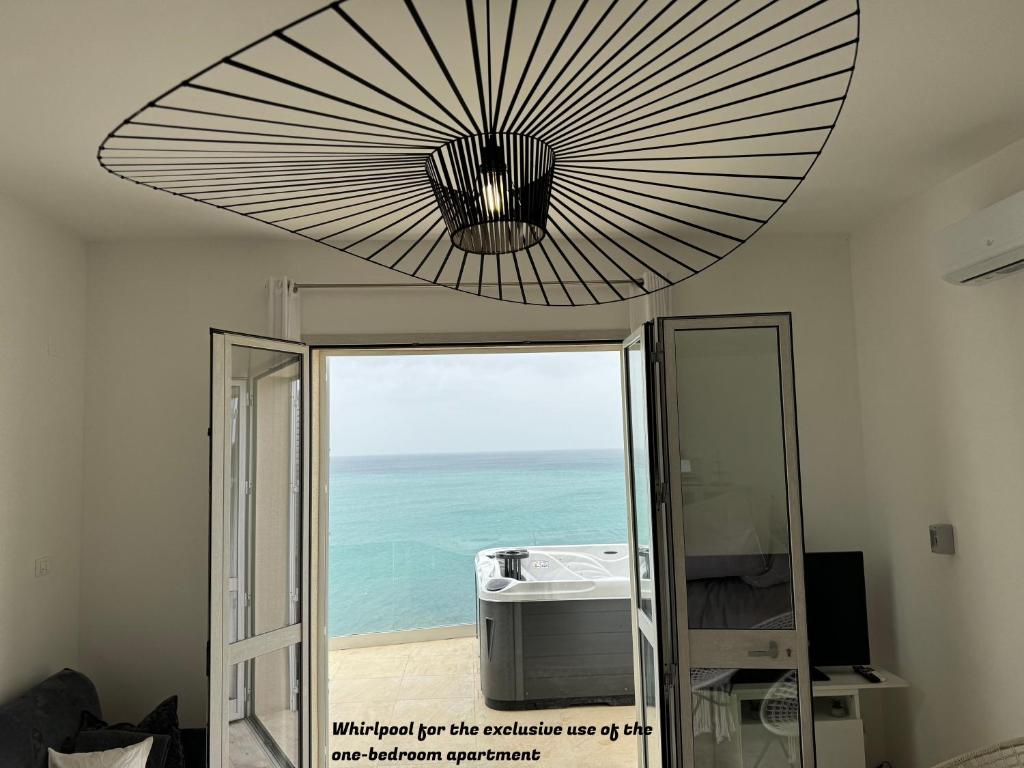 a large ceiling light in a room with the ocean at La Villa di Nonna Pina in Balestrate