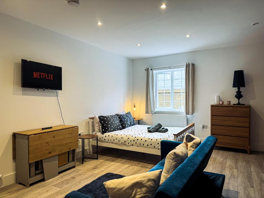 a living room with a couch and a bed at Apart Hotel Prime Maidstone Location in Maidstone