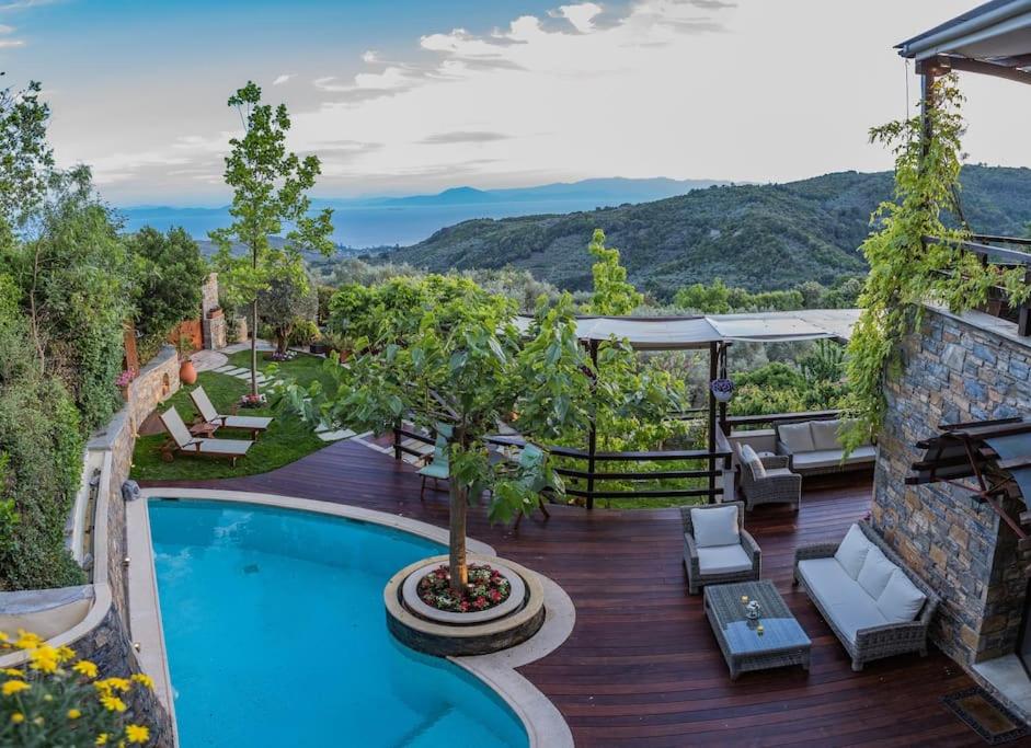 a pool on a deck with a view of the mountains at Aenaon Villa with Private Pool Panoramic view in Miléai