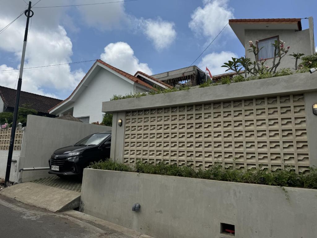 a black car parked in front of a house at Pandawa House Bali in Uluwatu
