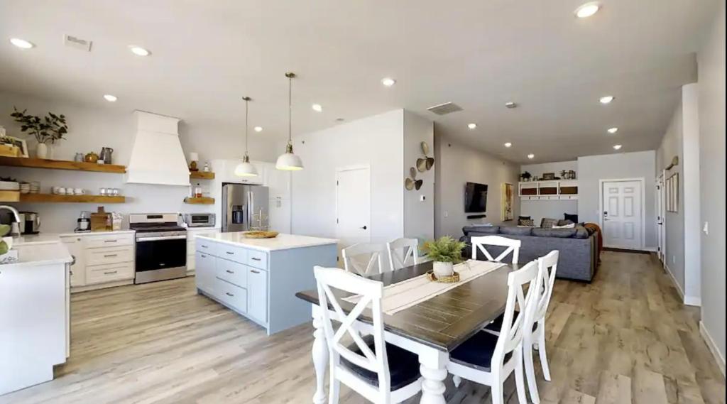 a kitchen and dining room with a table and chairs at Sweet Martini on Lake Kampeska in Watertown