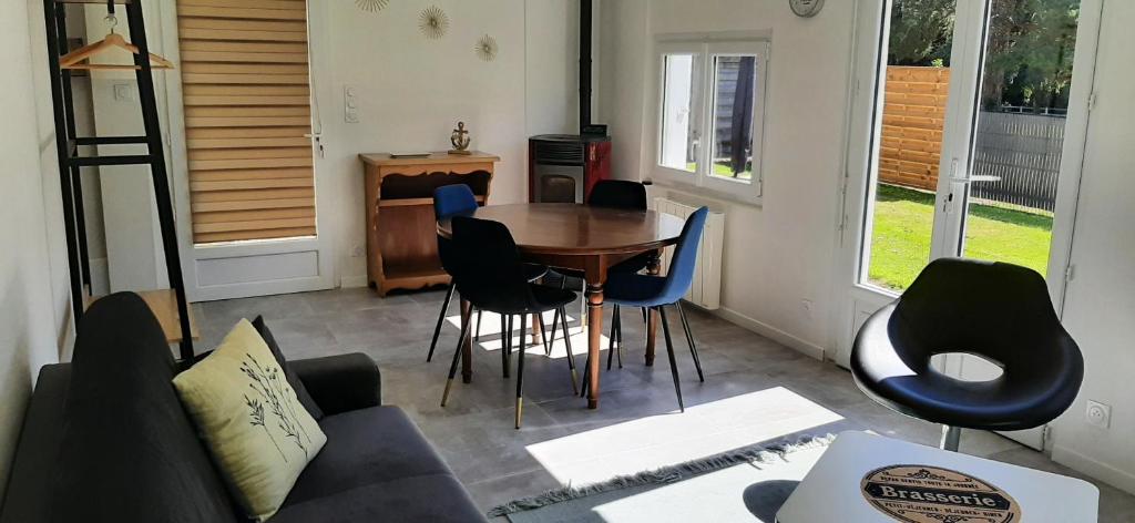 a living room with a table and chairs at GÎTE Le REFUGE in Lamballe Armor