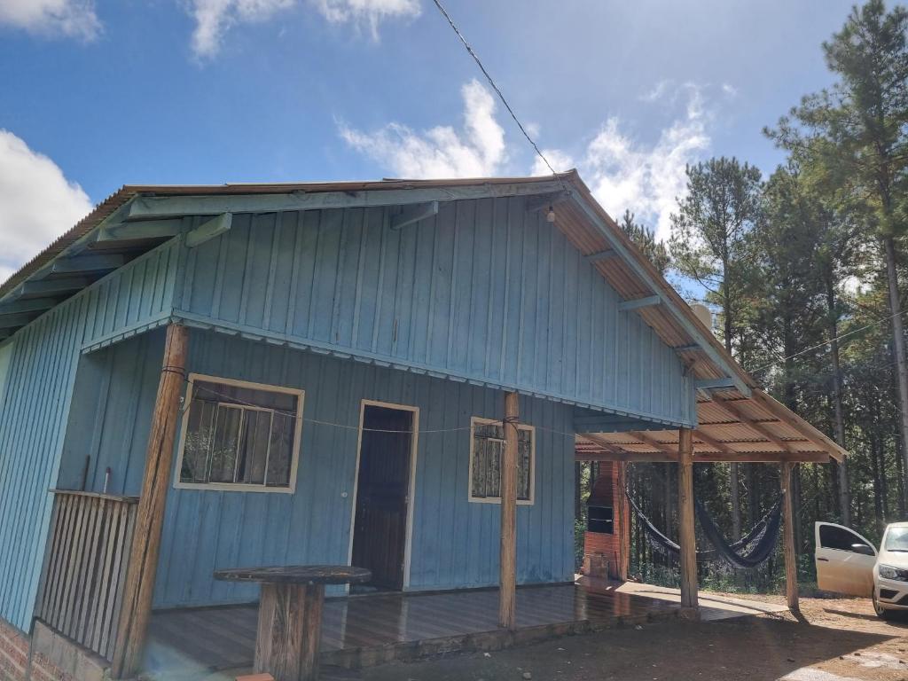 a blue house with a picnic table in front of it at Rancho do Pijuca real in Ortigueira