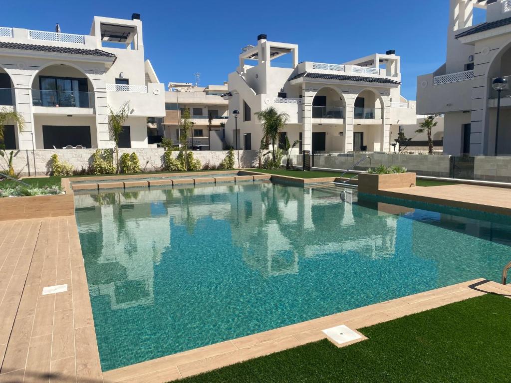 a large swimming pool in front of a building at Vera Apartment mit Garten in Ciudad Quesada