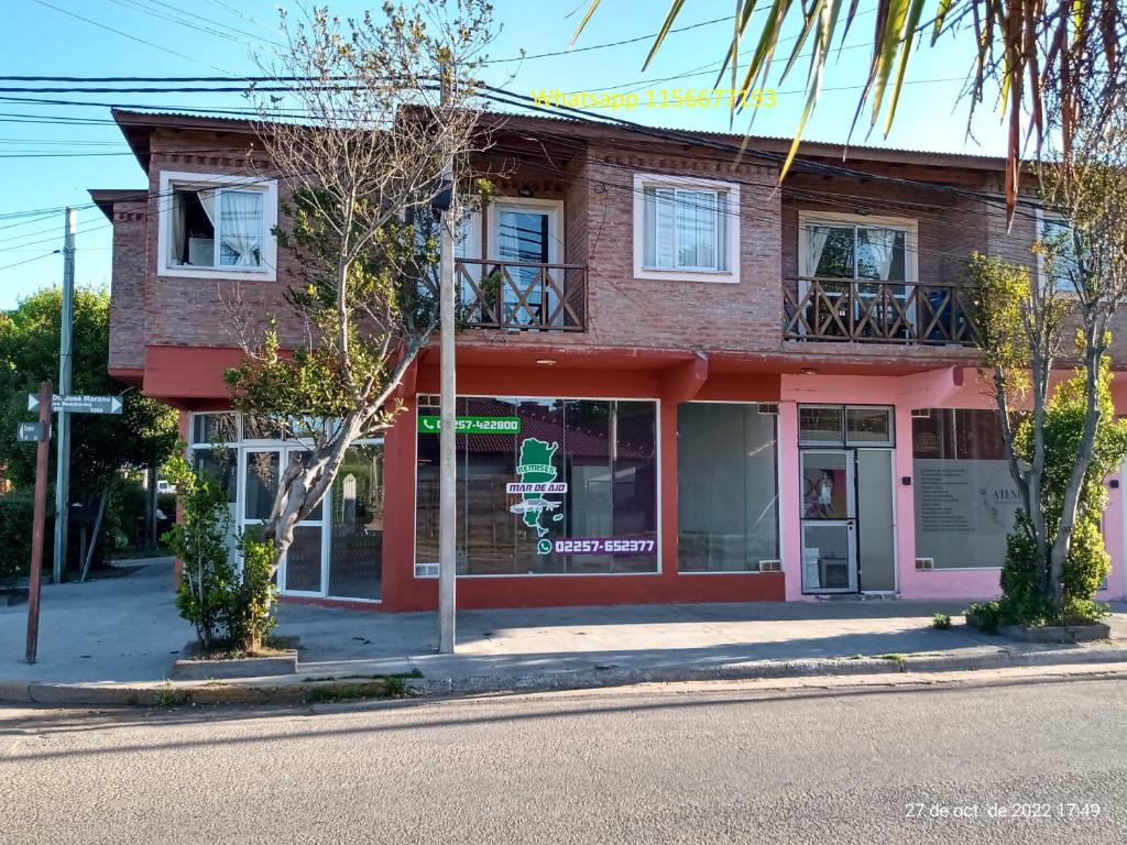 a building on the corner of a street at Departamentos Joaquin in Mar de Ajó