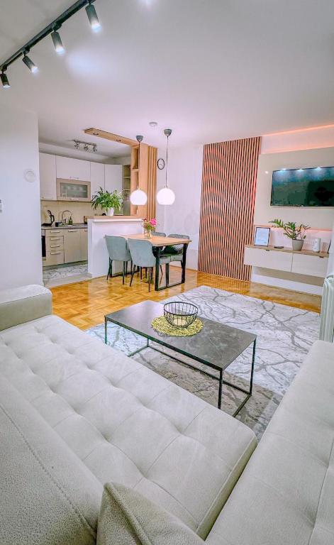 a living room with a couch and a table at PARK INN in Lukavica