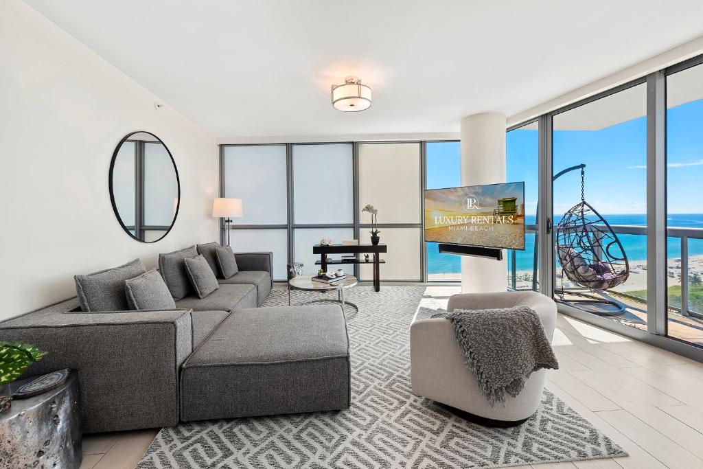 a living room with a couch and a tv at Oceanview Private Condo at The Setai -2604 in Miami Beach