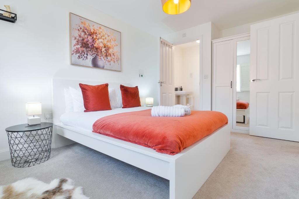 カンタベリーにあるModern Spacious House with Free Parking & Garden - Sleeps 6 - Perfect for Contractors & Familiesのベッドルーム(白いベッド、オレンジの毛布付)