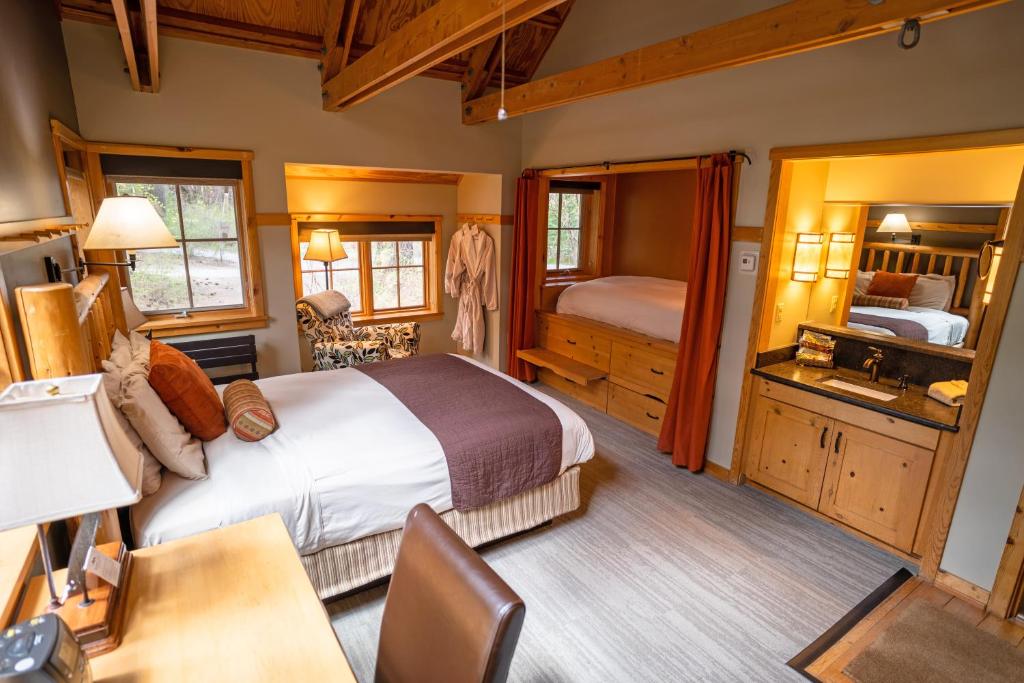 a bedroom with a bed and a desk in a room at Sleeping Lady Mountain Resort in Leavenworth