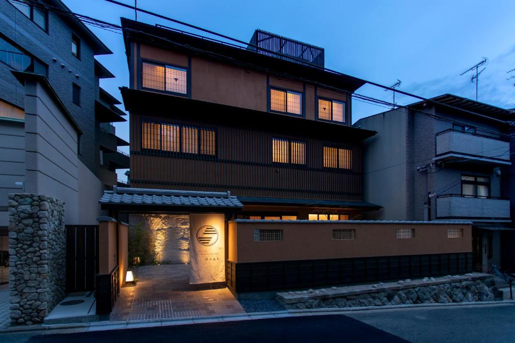 a building with its lights on in the night at Hotel Ethnography Kiyomizu Gojo in Kyoto