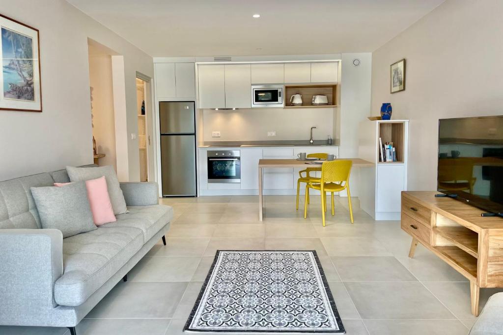 a living room with a couch and a dining room at Heifara city - Downtown Papeete in Papeete