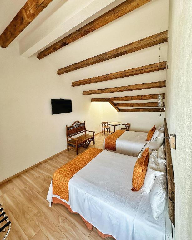 Postel nebo postele na pokoji v ubytování Hotel Ciudad Real Centro Historico