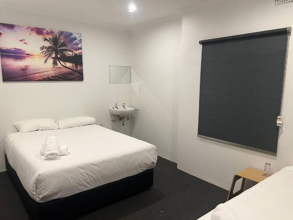 Postel nebo postele na pokoji v ubytování Plantation Hotel Coffs Harbour