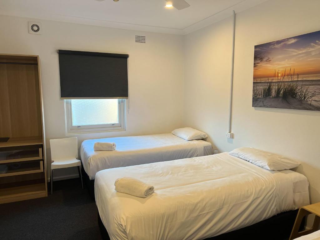 Postel nebo postele na pokoji v ubytování Plantation Hotel Coffs Harbour