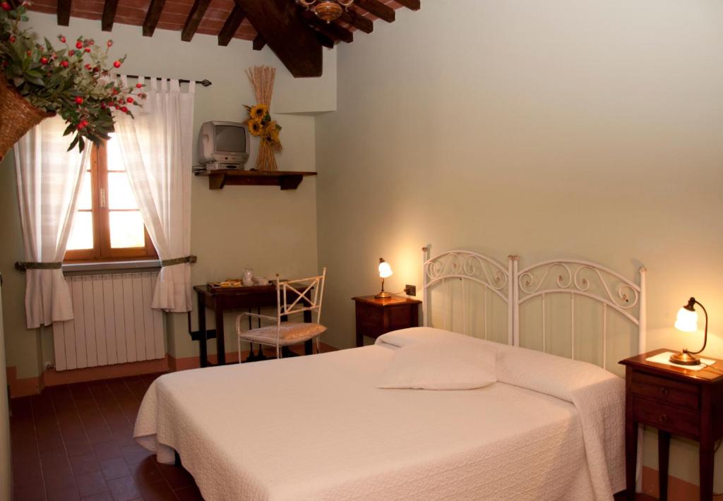 Łóżko lub łóżka w pokoju w obiekcie Agriturismo Fattoria Rozzalupi