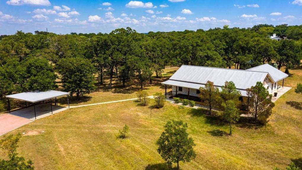 an aerial view of a house in the middle of a field at Pecan Farm Haus in Fredericksburg