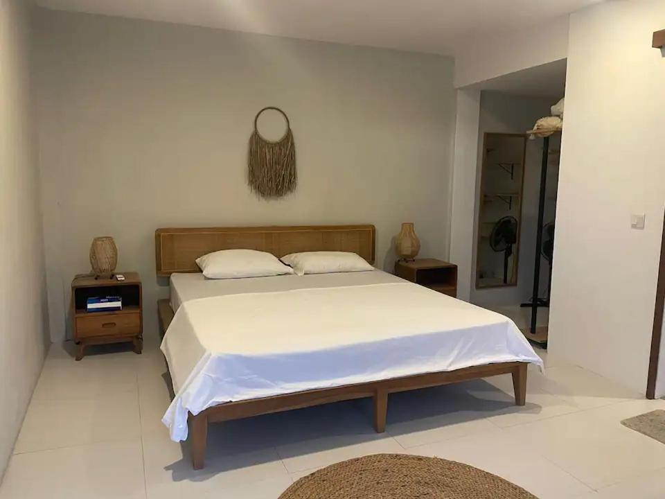 a bedroom with a bed and two night stands at Base Villa in Canggu