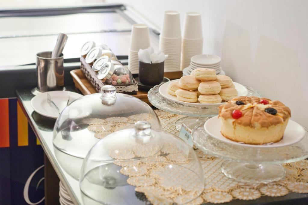 a buffet with cakes and cookies on a table at Just Enjoy Business Hotel in Tainan
