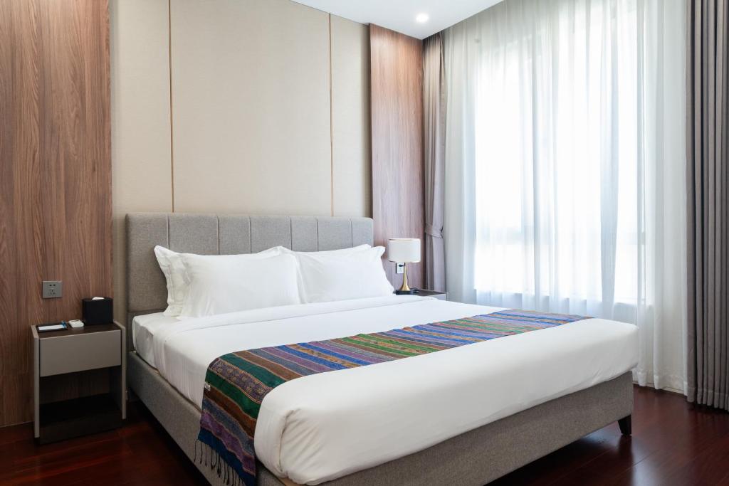 Postel nebo postele na pokoji v ubytování One Park Hotel & Residence