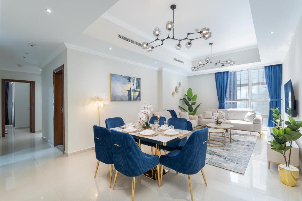 a dining room and living room with a table and chairs at Dunya Tower Luxury and 2 min walk to Dubai Mall and Burj Khalifa in heart of Downtown in Dubai