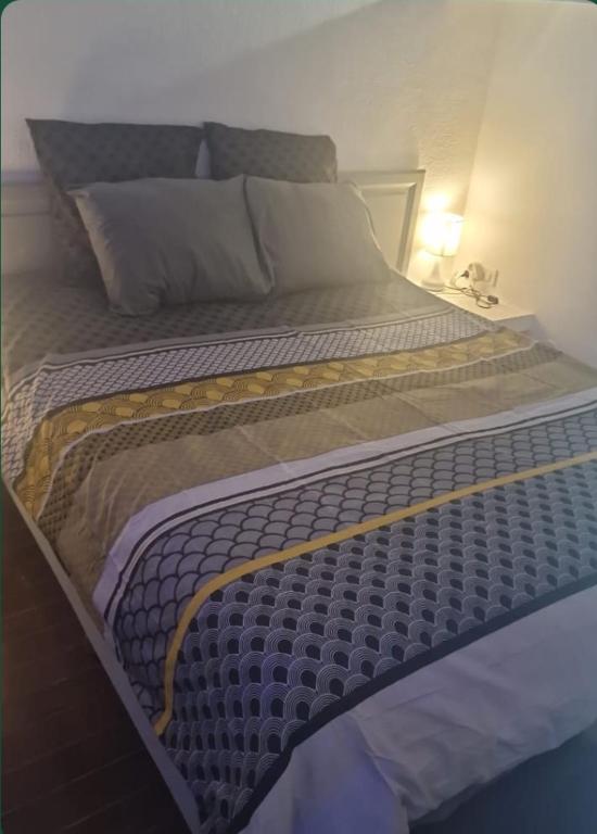 a large bed sitting in a room with at Studio Turkoise in Saint-François