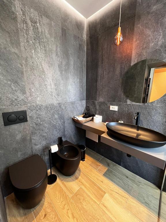 a bathroom with a sink and a toilet and a tub at Adalesia Hotel & Coffee in Turin