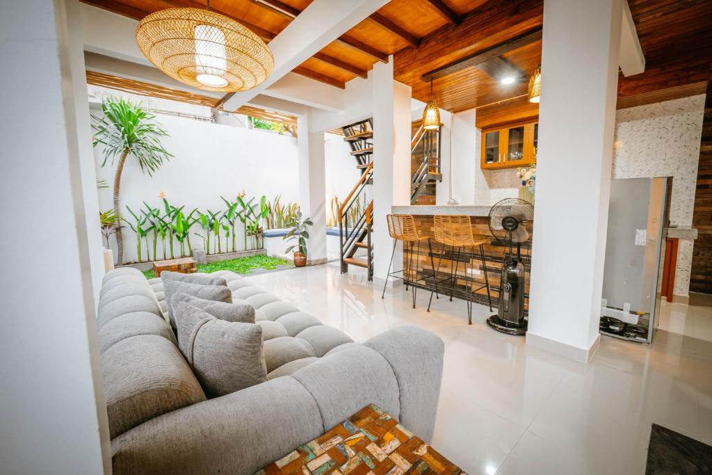 a living room with a couch and a fireplace at Villa Umah Seminyak in Seminyak