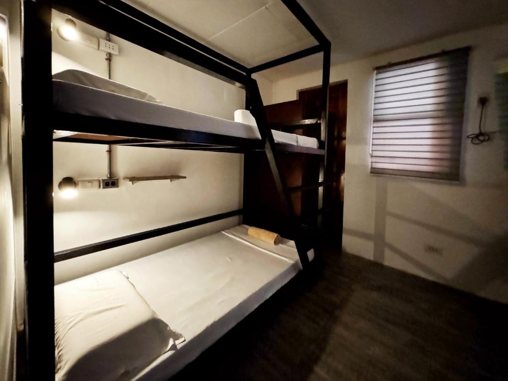 um quarto com 2 beliches num quarto em Ocean Breeze Hostel by Daily Sweet em Moalboal