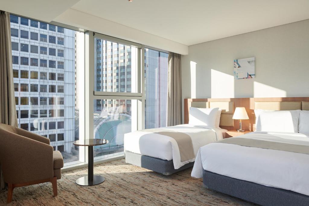 Postel nebo postele na pokoji v ubytování Stanford Hotel Myeongdong