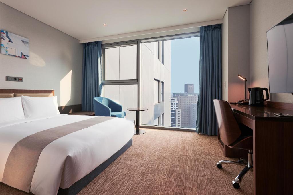 Postel nebo postele na pokoji v ubytování Stanford Hotel Myeongdong