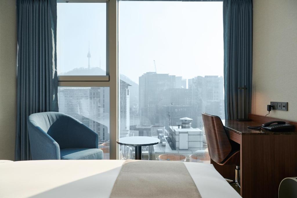 Postel nebo postele na pokoji v ubytování Stanford Hotel Myeongdong