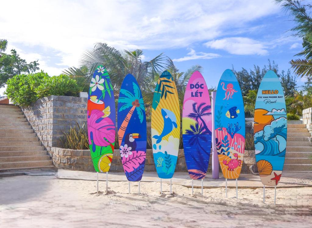 a group of surfboards are lined up in a row at TTC Van Phong Bay Resort - Himalaya Sauna & Steam Retreat Included in Ninh Hòa