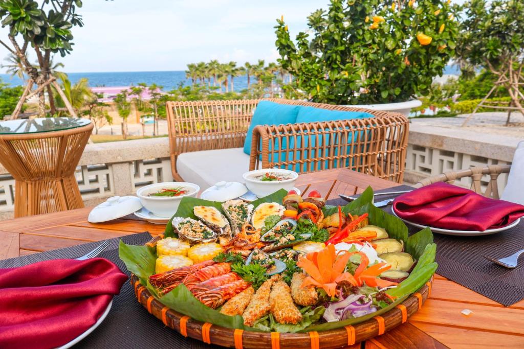 a table with a plate of food on top of it at TTC Van Phong Bay Resort - Himalaya Sauna & Steam Retreat Included in Ninh Hòa