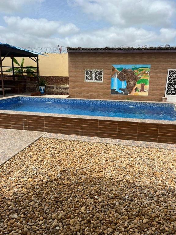 a large swimming pool next to a building at Sendou Cabano Villa Retreat in Siendou