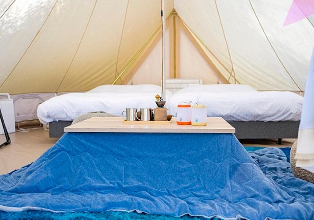 Postel nebo postele na pokoji v ubytování Takatakiko Glamping Resort